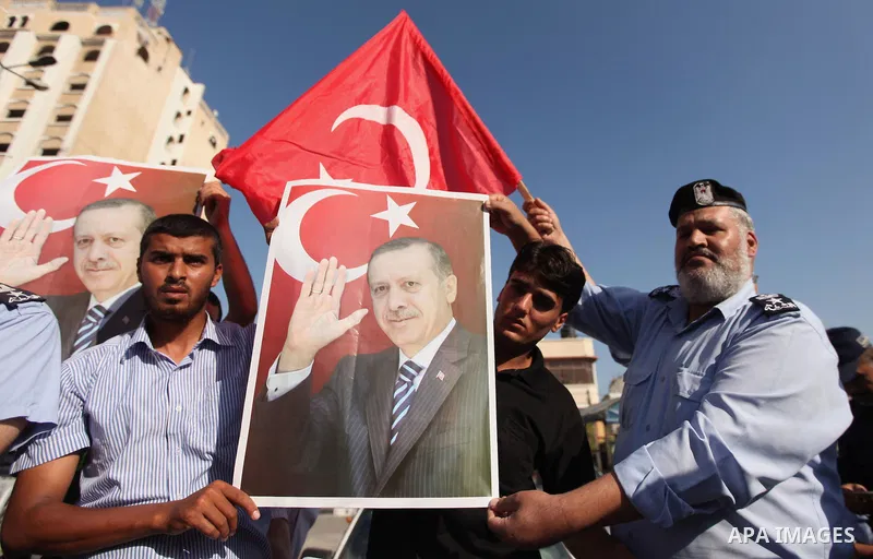 Palestinians hold banners during a protest against military coup attempt in Turkey, in Khan Younis in the southern Gaza strip, on July 16, 2016. President Recep Tayyip Erdogan battled to regain control over Turkey on Jul...