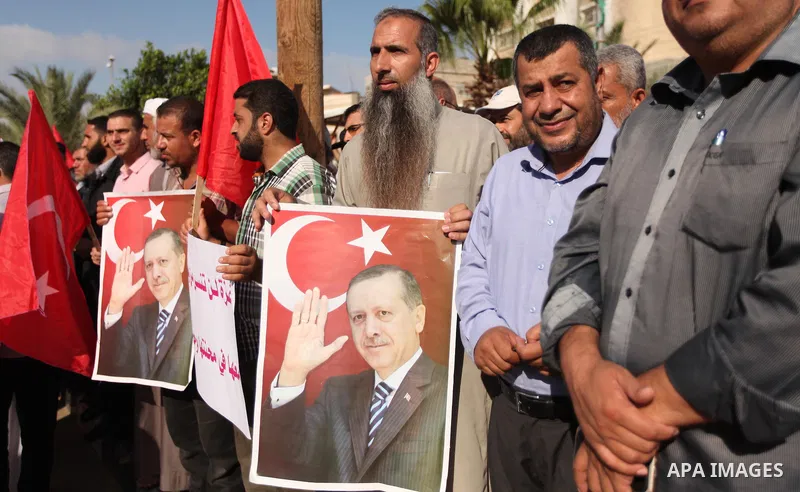 Palestinians hold banners during a protest against military coup attempt in Turkey, in Khan Younis in the southern Gaza strip, on July 16, 2016. President Recep Tayyip Erdogan battled to regain control over Turkey on Jul...