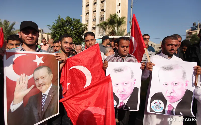 Palestinians hold banners during a protest against military coup attempt in Turkey, in Khan Younis in the southern Gaza strip, on July 16, 2016. President Recep Tayyip Erdogan battled to regain control over Turkey on Jul...