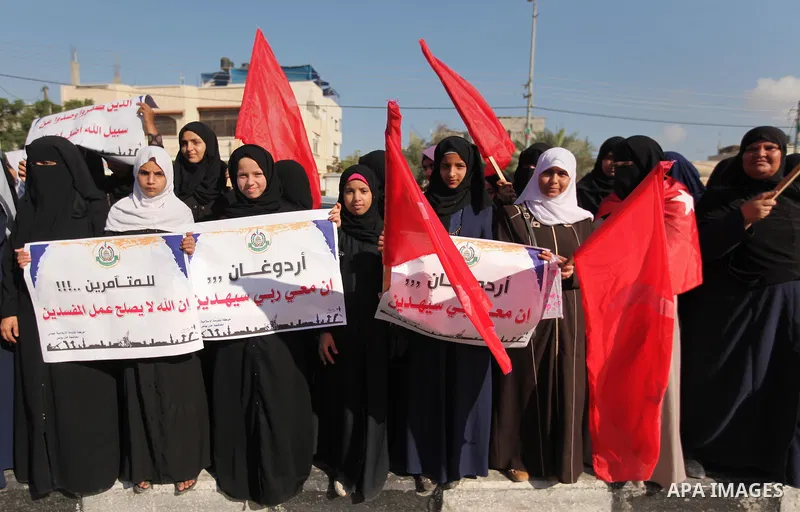 Palestinians hold banners during a protest against military coup attempt in Turkey, in Khan Younis in the southern Gaza strip, on July 16, 2016. President Recep Tayyip Erdogan battled to regain control over Turkey on Jul...