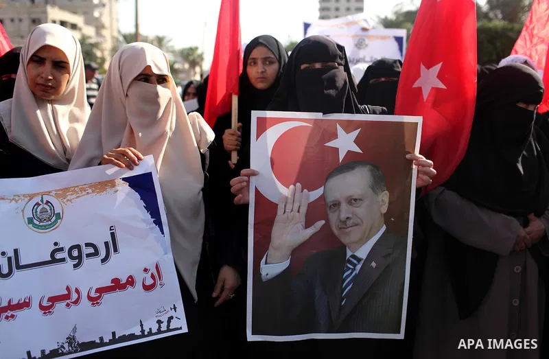 Palestinians hold banners during a protest against military coup attempt in Turkey, in Khan Younis in the southern Gaza strip, on July 16, 2016. President Recep Tayyip Erdogan battled to regain control over Turkey on Jul...