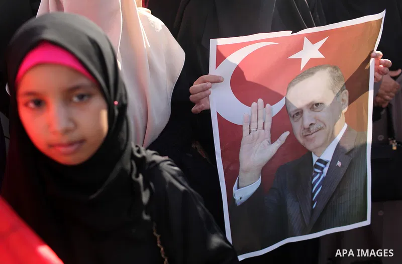 Palestinians hold banners during a protest against military coup attempt in Turkey, in Khan Younis in the southern Gaza strip, on July 16, 2016. President Recep Tayyip Erdogan battled to regain control over Turkey on Jul...