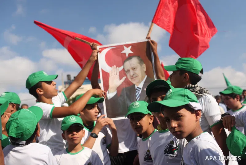Palestinians hold banners during a protest against military coup attempt in Turkey, in Khan Younis in the southern Gaza strip, on July 16, 2016. President Recep Tayyip Erdogan battled to regain control over Turkey on Jul...