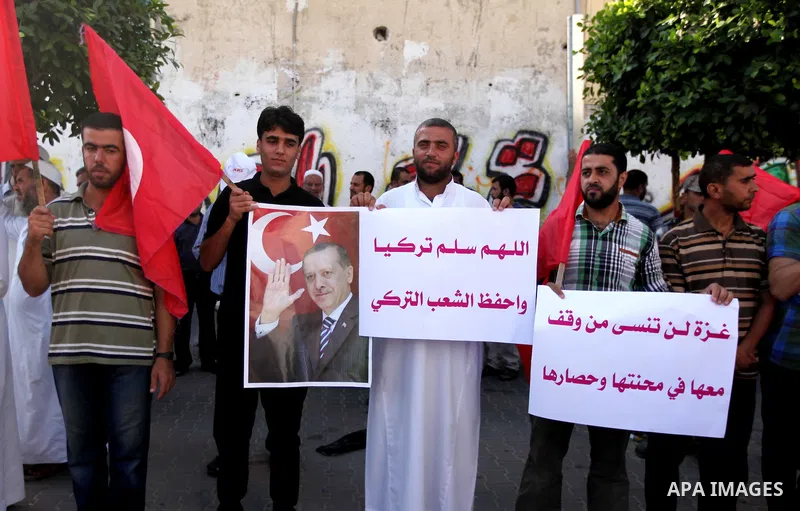 Palestinians hold banners during a protest against military coup attempt in Turkey, in Khan Younis in the southern Gaza strip, on July 16, 2016. President Recep Tayyip Erdogan battled to regain control over Turkey on Jul...