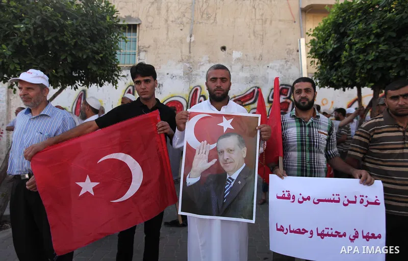 Palestinians hold banners during a protest against military coup attempt in Turkey, in Khan Younis in the southern Gaza strip, on July 16, 2016. President Recep Tayyip Erdogan battled to regain control over Turkey on Jul...