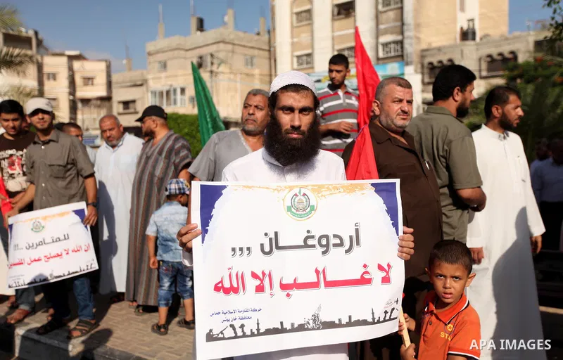 Palestinians hold banners during a protest against military coup attempt in Turkey, in Khan Younis in the southern Gaza strip, on July 16, 2016. President Recep Tayyip Erdogan battled to regain control over Turkey on Jul...