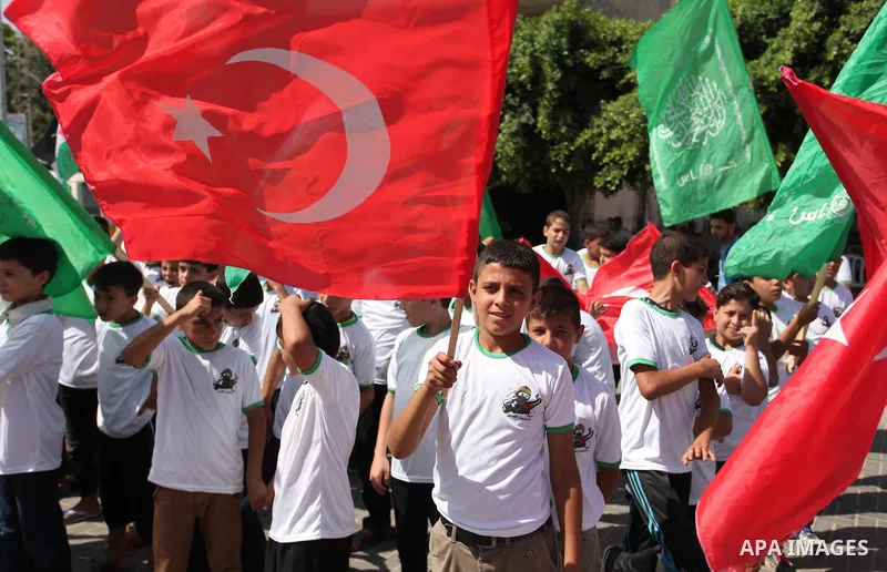 Palestinian supporters of the Hamas movement wave their national flag and Turkey's flag as they shout slogans against the military coup attempt in Turkey, during a demonstration in Gaza City, on July 16, 2016. Erdogan ba...