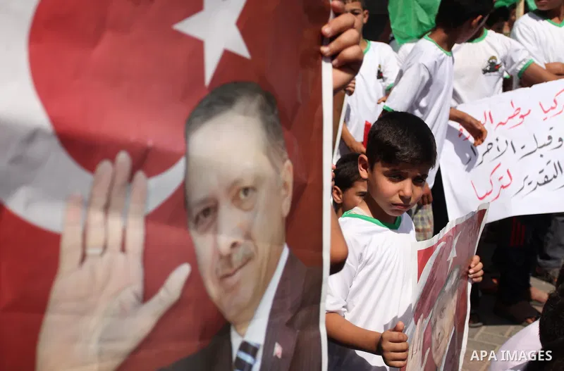 Palestinian supporters of the Hamas movement wave their national flag and Turkey's flag as they shout slogans against the military coup attempt in Turkey, during a demonstration in Gaza City, on July 16, 2016. Erdogan ba...