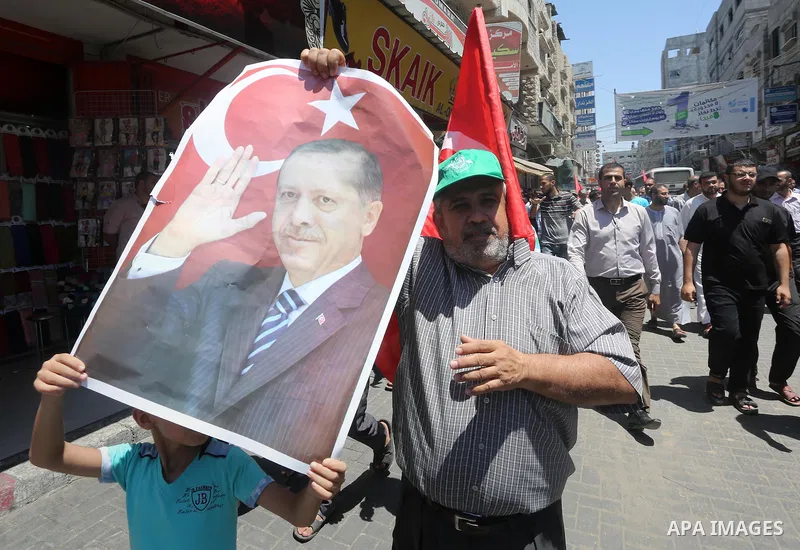 Palestinian supporters of the Hamas movement wave their national flag and Turkey's flag as they shout slogans against the military coup attempt in Turkey, during a demonstration in Gaza City, on July 16, 2016. Erdogan ba...