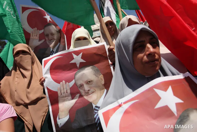 Palestinian supporters of the Hamas movement hold portraits of Turkish President Recep Tayyip Erdogan as they shout slogans against the military coup attempt in Turkey, during a demonstration in Gaza City, on July 17, 20...
