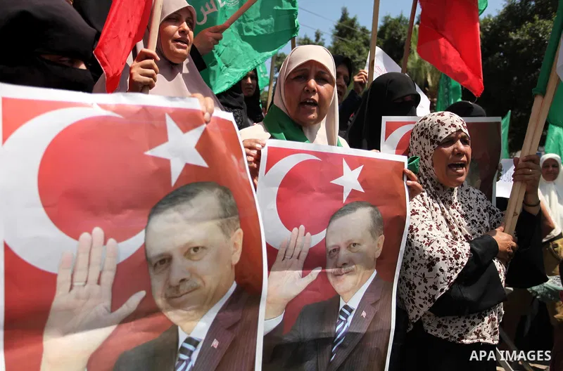 Palestinian supporters of the Hamas movement hold portraits of Turkish President Recep Tayyip Erdogan as they shout slogans against the military coup attempt in Turkey, during a demonstration in Gaza City, on July 17, 20...