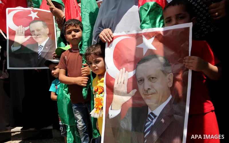 Palestinian supporters of the Hamas movement hold portraits of Turkish President Recep Tayyip Erdogan as they shout slogans against the military coup attempt in Turkey, during a demonstration in Gaza City, on July 17, 20...