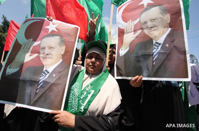 Palestinian supporters of the Hamas movement hold portraits of Turkish President Recep Tayyip Erdogan as they shout slogans against the military coup attempt in Turkey, during a demonstration in Gaza City, on July 17, 20...
