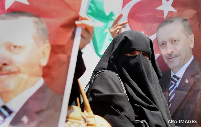 Palestinian supporters of the Hamas movement hold portraits of Turkish President Recep Tayyip Erdogan as they shout slogans against the military coup attempt in Turkey, during a demonstration in Gaza City, on July 17, 20...