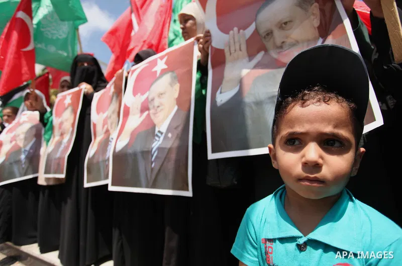 Palestinian supporters of the Hamas movement hold portraits of Turkish President Recep Tayyip Erdogan as they shout slogans against the military coup attempt in Turkey, during a demonstration in Gaza City, on July 17, 20...