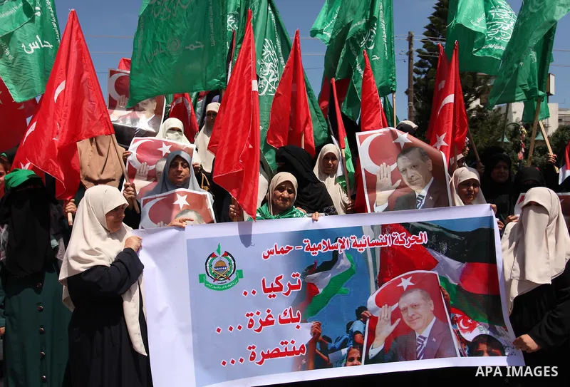 Palestinian supporters of the Hamas movement hold portraits of Turkish President Recep Tayyip Erdogan as they shout slogans against the military coup attempt in Turkey, during a demonstration in Gaza City, on July 17, 20...