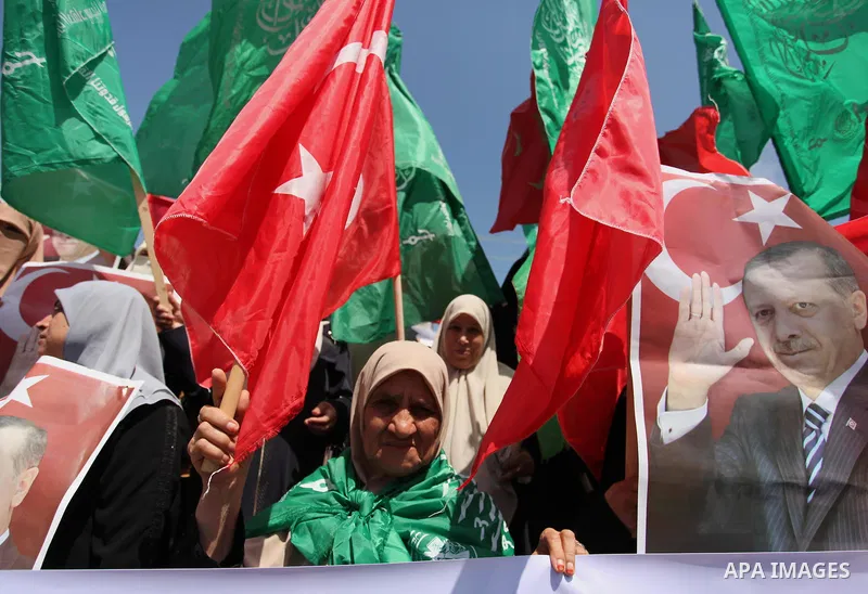 Palestinian supporters of the Hamas movement hold portraits of Turkish President Recep Tayyip Erdogan as they shout slogans against the military coup attempt in Turkey, during a demonstration in Gaza City, on July 17, 20...