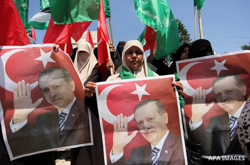 Palestinian supporters of the Hamas movement hold portraits of Turkish President Recep Tayyip Erdogan as they shout slogans against the military coup attempt in Turkey, during a demonstration in Gaza City, on July 17, 20...
