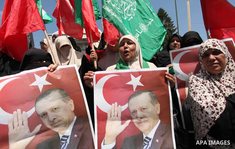 Palestinian supporters of the Hamas movement hold portraits of Turkish President Recep Tayyip Erdogan as they shout slogans against the military coup attempt in Turkey, during a demonstration in Gaza City, on July 17, 20...