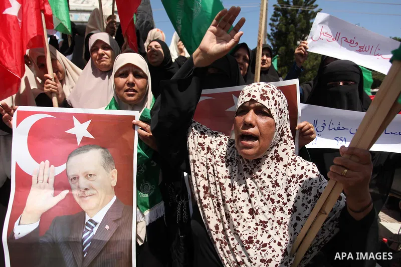 Palestinian supporters of the Hamas movement hold portraits of Turkish President Recep Tayyip Erdogan as they shout slogans against the military coup attempt in Turkey, during a demonstration in Gaza City, on July 17, 20...