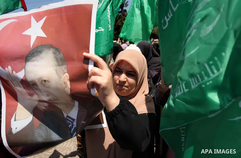 Palestinian supporters of the Hamas movement hold portraits of Turkish President Recep Tayyip Erdogan as they shout slogans against the military coup attempt in Turkey, during a demonstration in Gaza City, on July 17, 20...