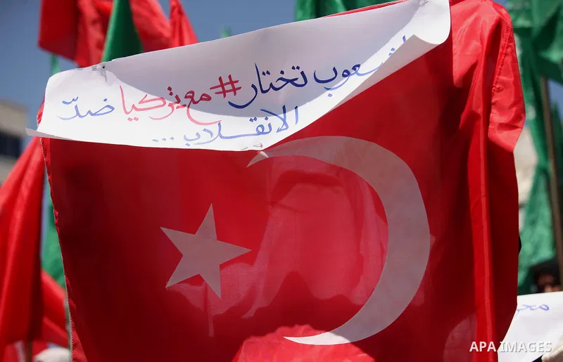 Palestinian supporters of the Hamas movement hold portraits of Turkish President Recep Tayyip Erdogan as they shout slogans against the military coup attempt in Turkey, during a demonstration in Gaza City, on July 17, 20...