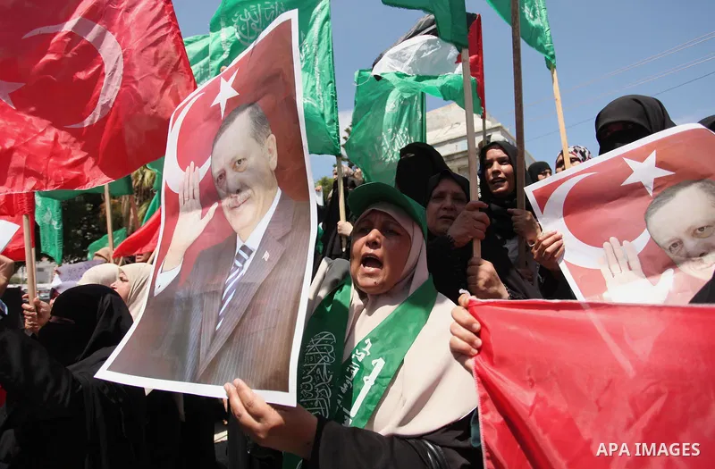 Palestinian supporters of the Hamas movement hold portraits of Turkish President Recep Tayyip Erdogan as they shout slogans against the military coup attempt in Turkey, during a demonstration in Gaza City, on July 17, 20...