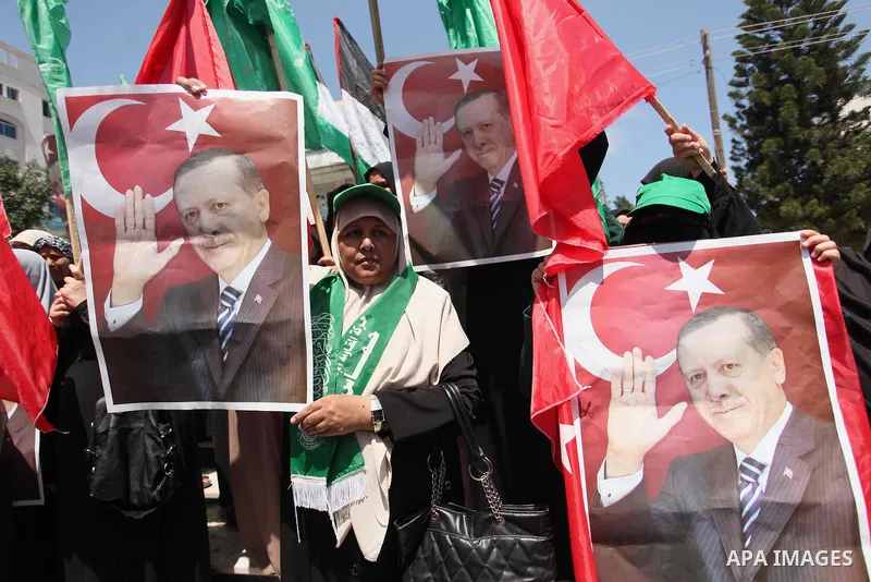 Palestinian supporters of the Hamas movement hold portraits of Turkish President Recep Tayyip Erdogan as they shout slogans against the military coup attempt in Turkey, during a demonstration in Gaza City, on July 17, 20...