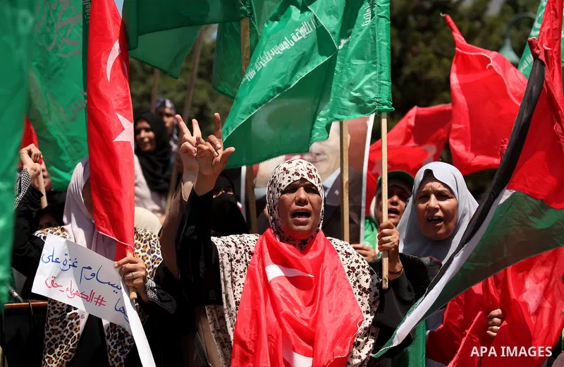 Palestinian supporters of the Hamas movement hold portraits of Turkish President Recep Tayyip Erdogan as they shout slogans against the military coup attempt in Turkey, during a demonstration in Gaza City, on July 17, 20...