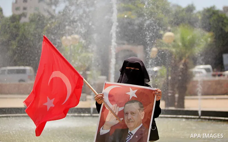 Palestinian supporters of the Hamas movement hold portraits of Turkish President Recep Tayyip Erdogan as they shout slogans against the military coup attempt in Turkey, during a demonstration in Gaza City, on July 17, 20...