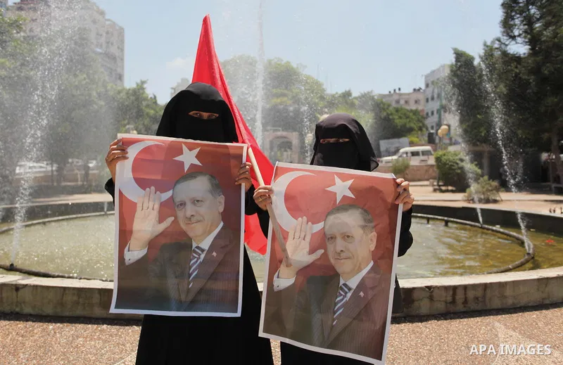 Palestinian supporters of the Hamas movement hold portraits of Turkish President Recep Tayyip Erdogan as they shout slogans against the military coup attempt in Turkey, during a demonstration in Gaza City, on July 17, 20...