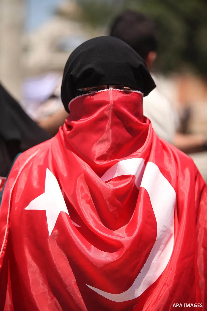 Palestinian supporters of the Hamas movement hold portraits of Turkish President Recep Tayyip Erdogan as they shout slogans against the military coup attempt in Turkey, during a demonstration in Gaza City, on July 17, 20...