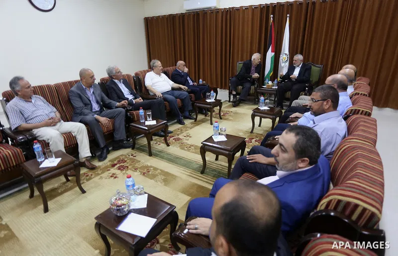 Senior Hamas leader Ismail Haniyeh meets with Palestinian Central Elections Commission chief, Hanna Nasser, in Gaza city on July 17, 2016. Photo by Mohammed Asad