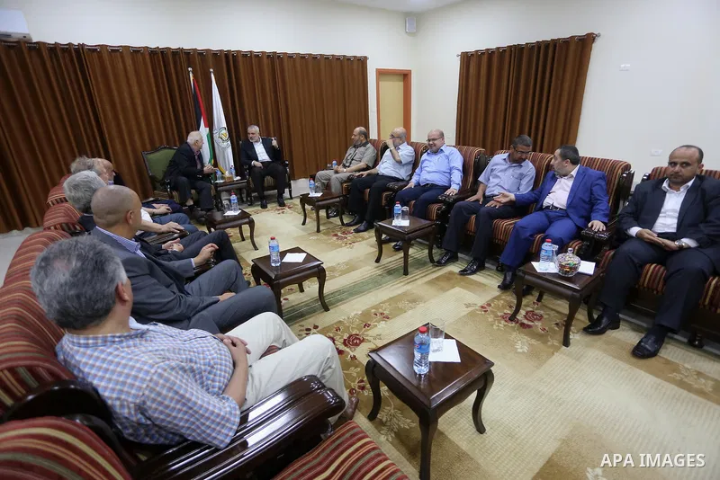 Senior Hamas leader Ismail Haniyeh meets with Palestinian Central Elections Commission chief, Hanna Nasser, in Gaza city on July 17, 2016. Photo by Mohammed Asad