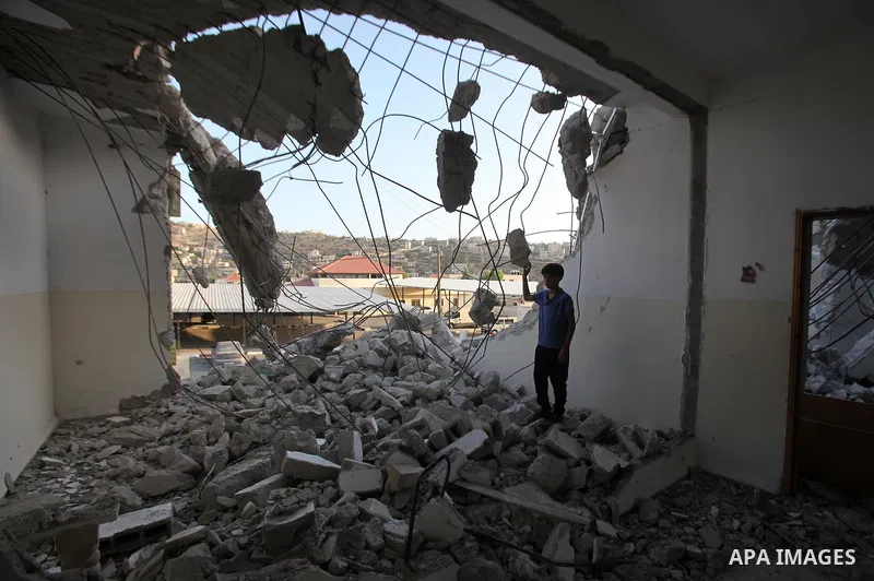 A Palestinian man checks on July 18, 2016 the rubble of a house belonging to a Palestinian man accused by Israeli authorities in taking part in an attack in Jerusalem in which an Israeli policewoman was killed, after it...
