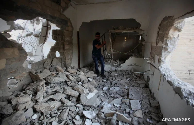 A Palestinian man checks on July 18, 2016 the rubble of a house belonging to a Palestinian man accused by Israeli authorities in taking part in an attack in Jerusalem in which an Israeli policewoman was killed, after it...