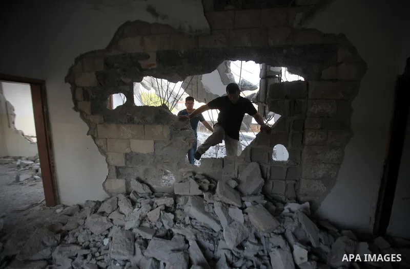 Palestinian men check on July 18, 2016 the rubble of a house belonging to a Palestinian man accused by Israeli authorities in taking part in an attack in Jerusalem in which an Israeli policewoman was killed, after it was...