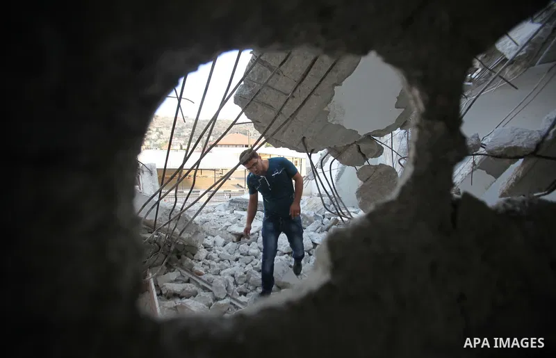 A Palestinian man checks on July 18, 2016 the rubble of a house belonging to a Palestinian man accused by Israeli authorities in taking part in an attack in Jerusalem in which an Israeli policewoman was killed, after it...