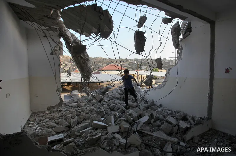 A Palestinian man checks on July 18, 2016 the rubble of a house belonging to a Palestinian man accused by Israeli authorities in taking part in an attack in Jerusalem in which an Israeli policewoman was killed, after it...