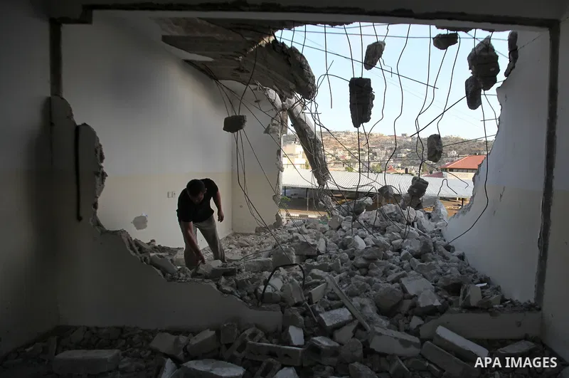 A Palestinian man checks on July 18, 2016 the rubble of a house belonging to a Palestinian man accused by Israeli authorities in taking part in an attack in Jerusalem in which an Israeli policewoman was killed, after it...