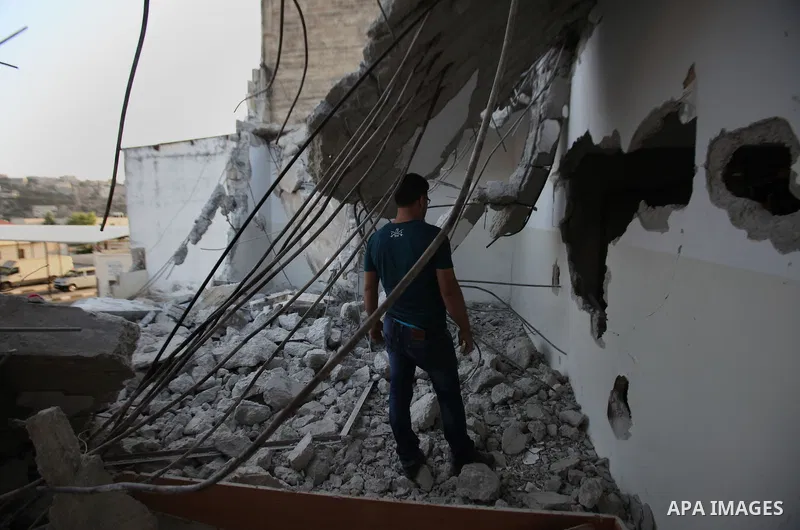 A Palestinian man checks on July 18, 2016 the rubble of a house belonging to a Palestinian man accused by Israeli authorities in taking part in an attack in Jerusalem in which an Israeli policewoman was killed, after it...
