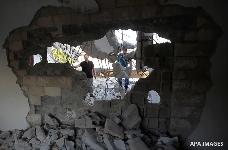 Palestinian men check on July 18, 2016 the rubble of a house belonging to a Palestinian man accused by Israeli authorities in taking part in an attack in Jerusalem in which an Israeli policewoman was killed, after it was...