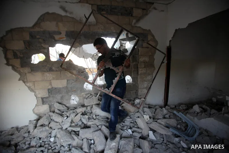 Palestinian men check on July 18, 2016 the rubble of a house belonging to a Palestinian man accused by Israeli authorities in taking part in an attack in Jerusalem in which an Israeli policewoman was killed, after it was...