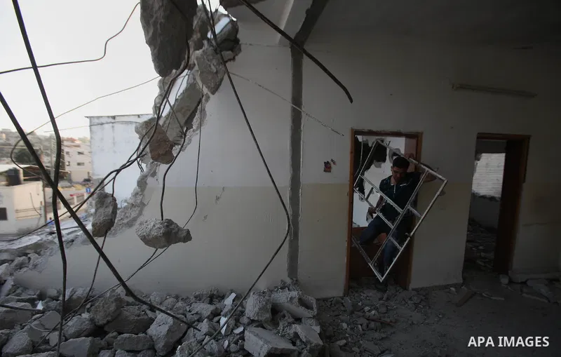 Palestinian men check on July 18, 2016 the rubble of a house belonging to a Palestinian man accused by Israeli authorities in taking part in an attack in Jerusalem in which an Israeli policewoman was killed, after it was...