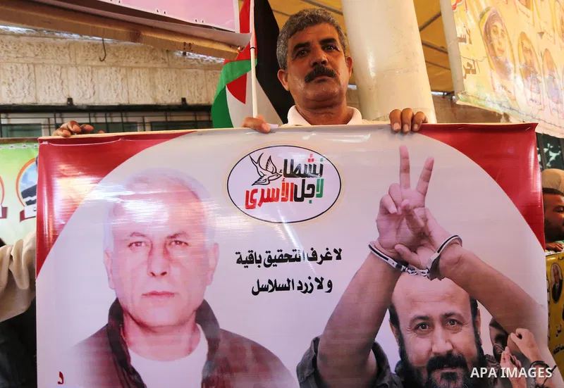 Palestinians take part in a protest demanding release the prisoners in Israeli jails, in front of Red cross office, in Gaza city, on July 18, 2016. Photo by Mohammed Asad