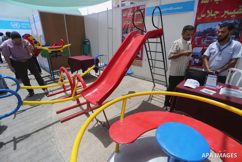 Palestinians attend the opening of an exhibition, in Gaza city, on July 18, 2016. Photo by Mohammed Asad