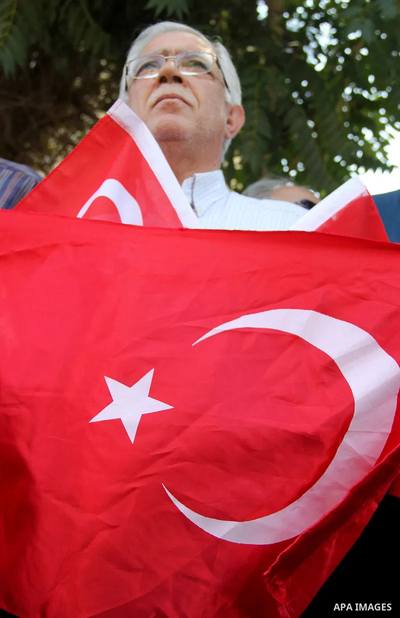Palestinians wave Turkish flags during a protest against the military coup attempt in Turkey, in front of the Turkish consulate in east Jerusalem on July 18, 2016. Photo by Mahfouz Abu Turk
