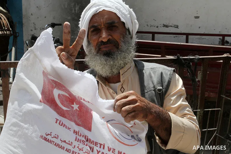 Palestinians receive Turkish aid at an aid distribution centre of the United Nations Relief and Works Agency (UNRWA) in the southern Gaza Strip town of Rafah, on July 18, 2016. Photo by Abed Rahim Khatib