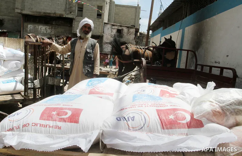Palestinians receive Turkish aid at an aid distribution centre of the United Nations Relief and Works Agency (UNRWA) in the southern Gaza Strip town of Rafah, on July 18, 2016. Photo by Abed Rahim Khatib