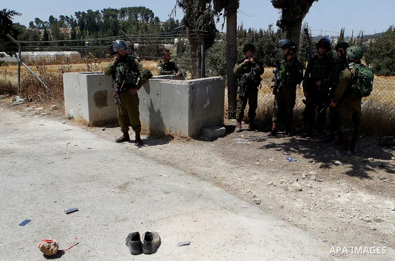 Israeli soldiers are seen at the site of a stabbing attack by a Palestinian man next to the entrance of the al-Arub refugee camp near the city of Hebron in the Israeli-occupied West Bank on July 18, 2016 in which two sol...